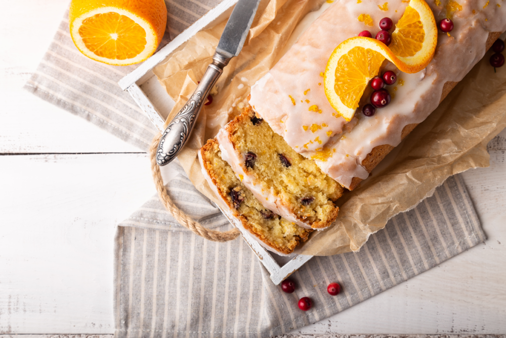 Freshly baked cranberry orange bread with a golden crust and bright cranberries.