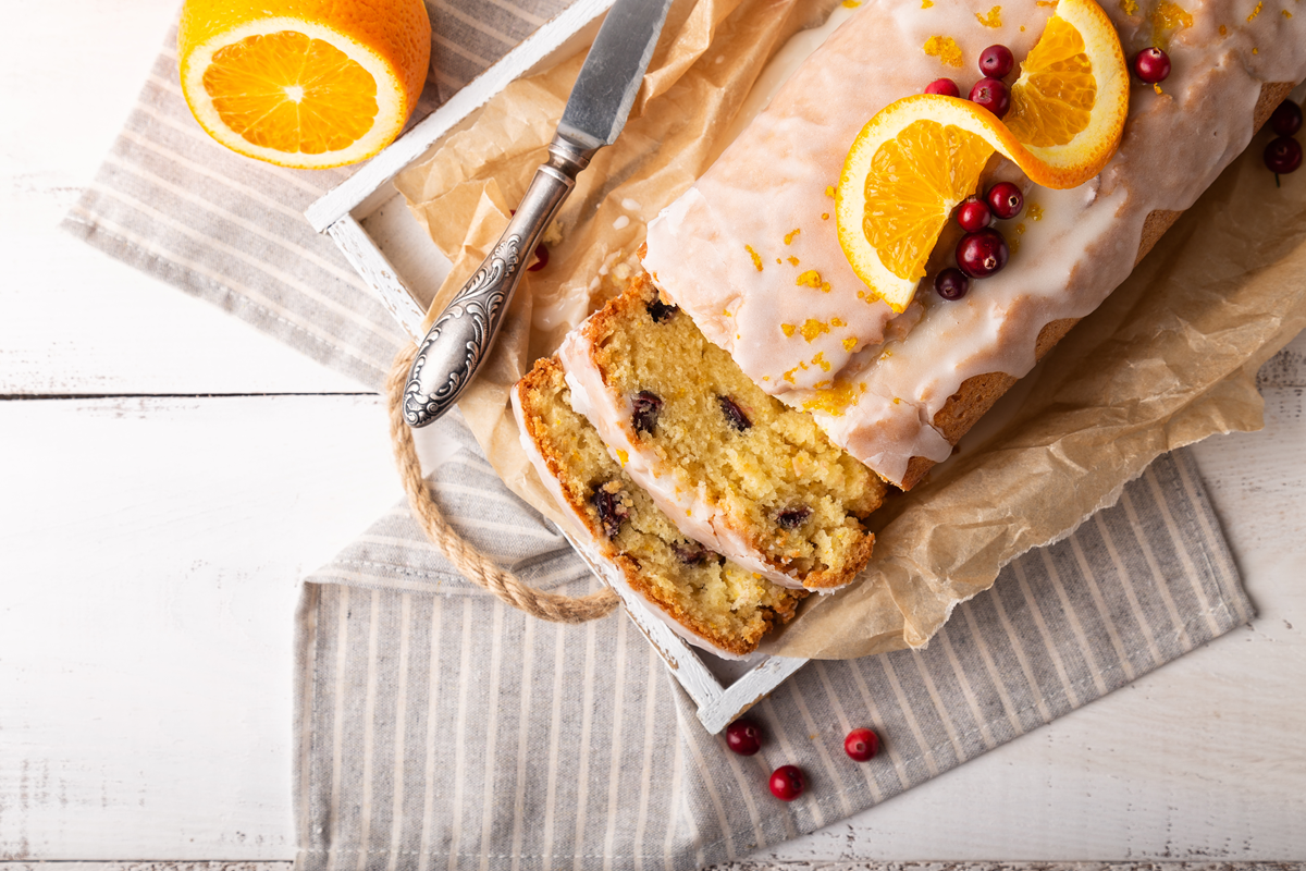 Freshly baked cranberry orange bread with a golden crust and bright cranberries.