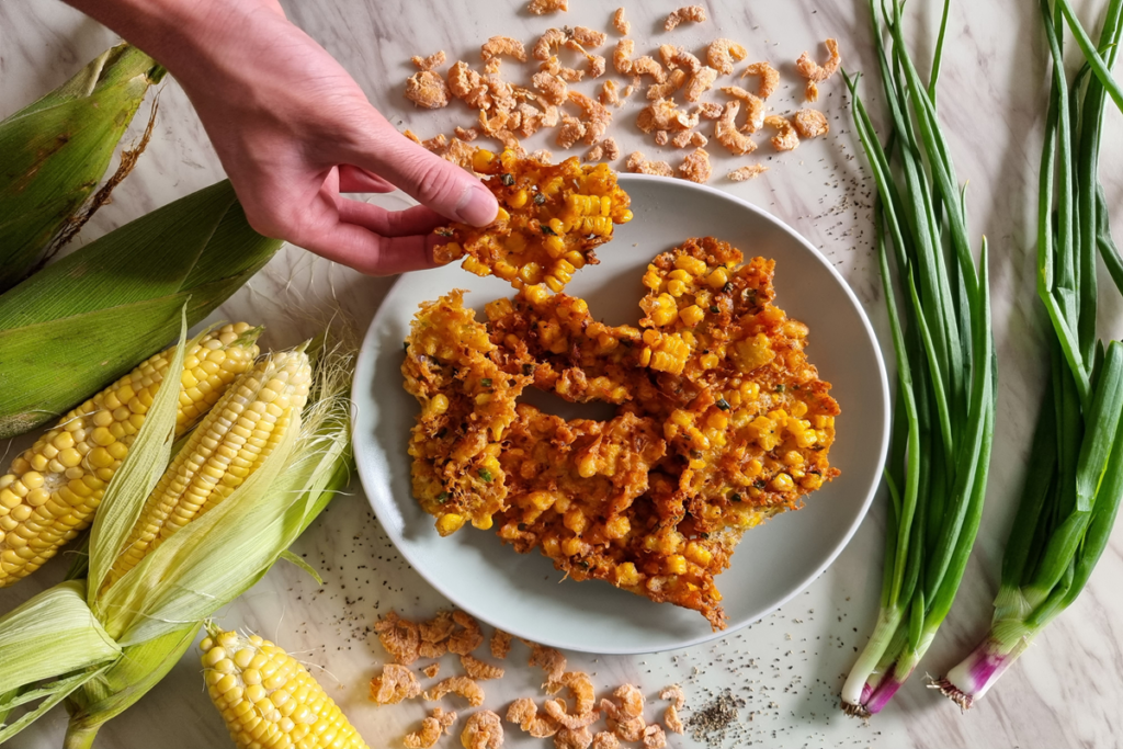 Crispy golden old fashioned corn fritters on a plate