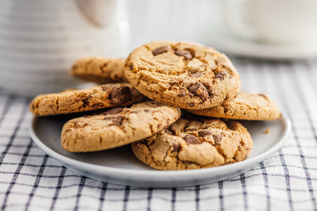 A plate of freshly baked brown butter chocolate chip cookies with golden edges and melty chocolate chunks.