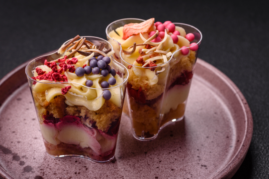 Vegan dessert trifle with layers of cake, custard, and berries