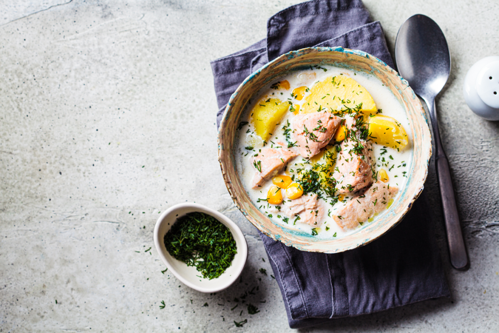 Bowl of creamy fish chowder with potatoes and corn