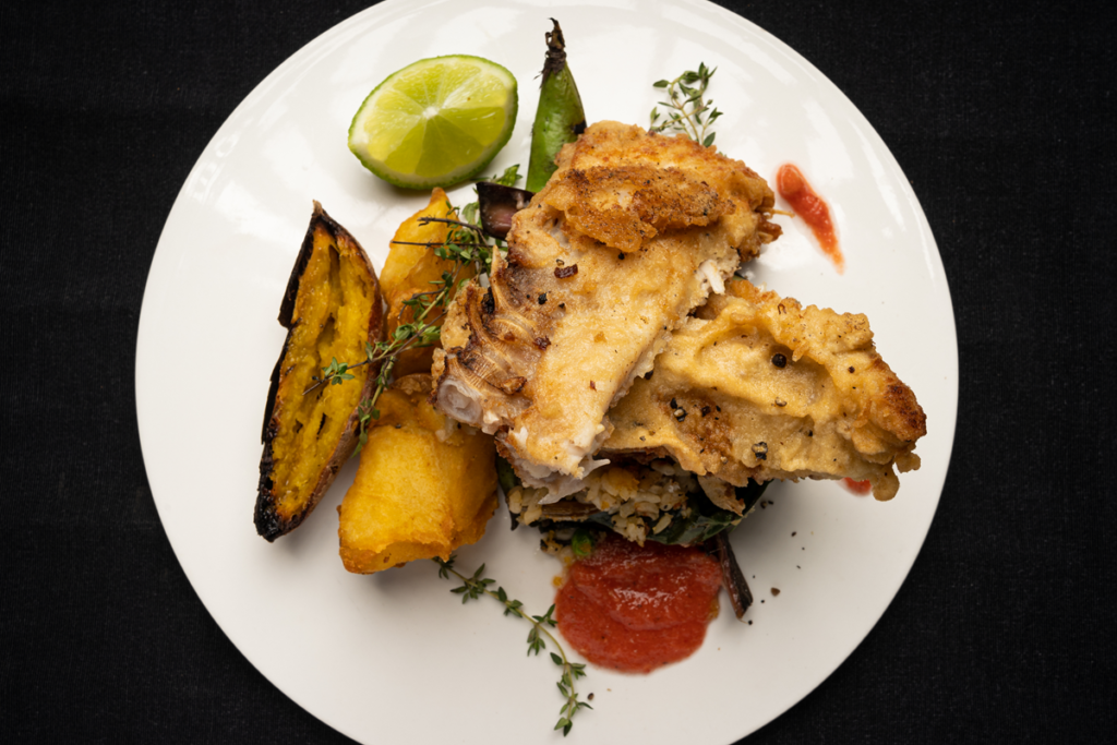 Crispy fried fish with rosemary served with roasted potatoes