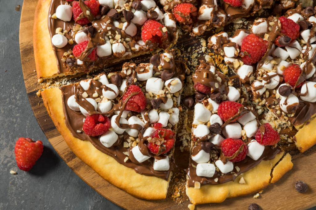 Sweet chocolate hazelnut pizza pastry topped with fresh strawberries