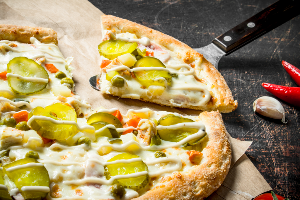 Pickle pie pizza with vegetables and cheese toppings