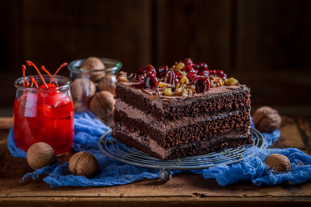 "Slice of chocolate cherry cake with walnuts."