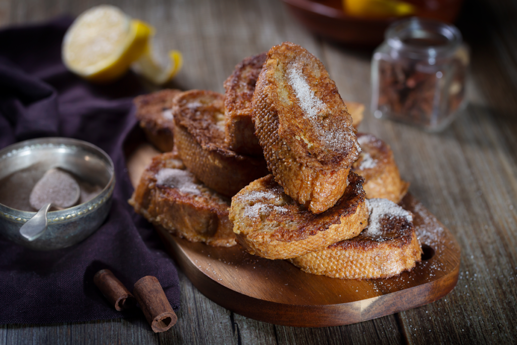 "Traditional Spanish Torrijas dessert with sugar and cinnamon."