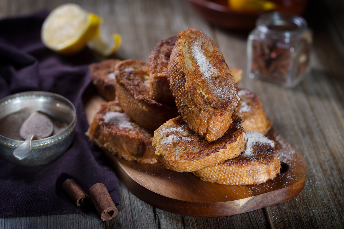 "Traditional Spanish Torrijas dessert with sugar and cinnamon."